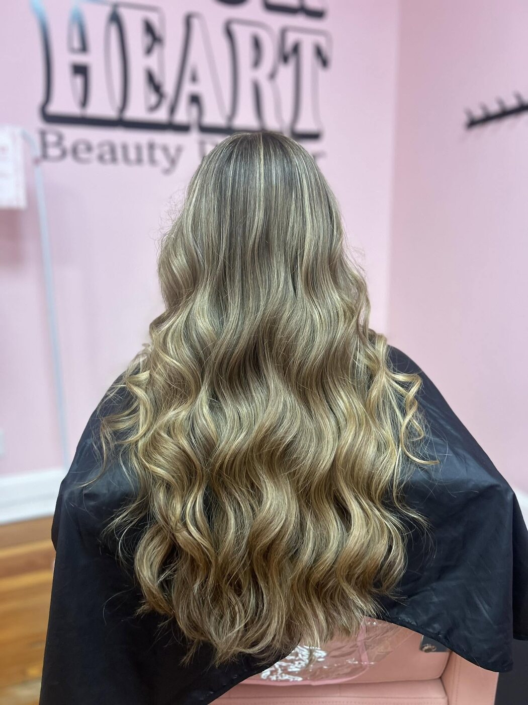 Dimensional blonde with woven highlights and soft waves by Kylie